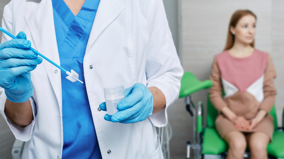 Doctor holding pap smear swab test