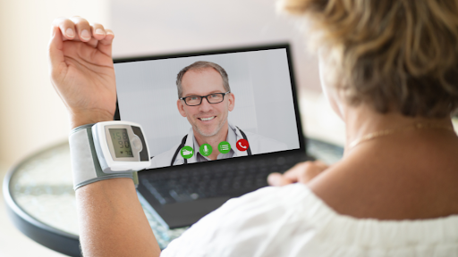 Person taking vital signs while on telehealth video call