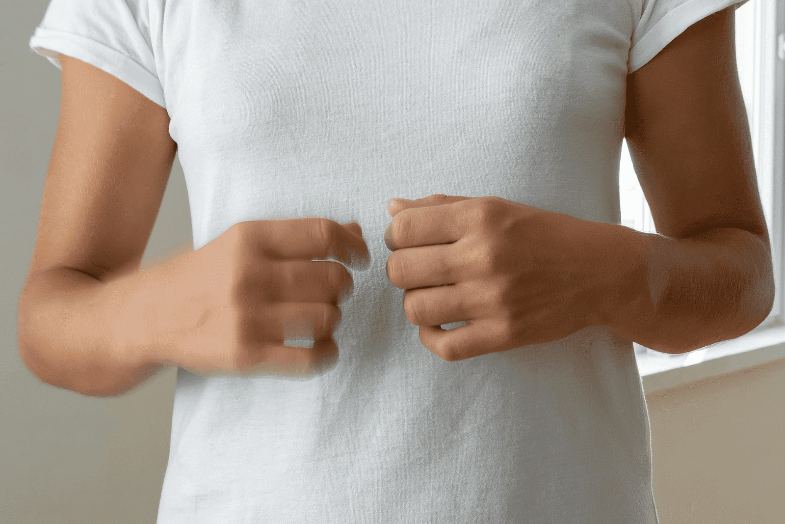 Person fidgeting with hands, showing signs of anxiety or nervousness.