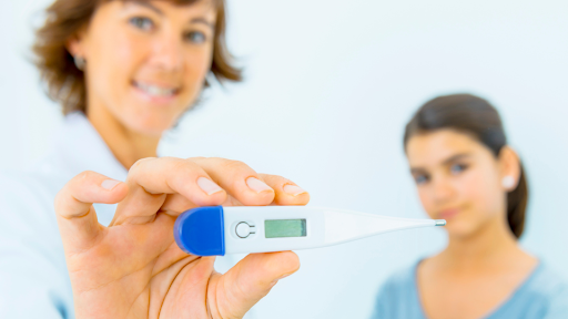 Woman holding up thermometer