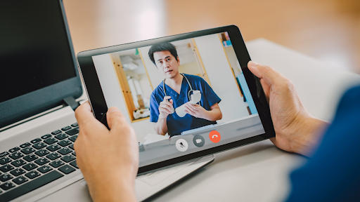 Person using tablet to speak with a doctor on a video call