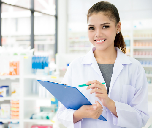 Pharmacist holding a clipboard and writing.