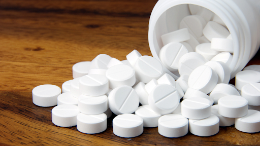 White pills spilling out of the jar