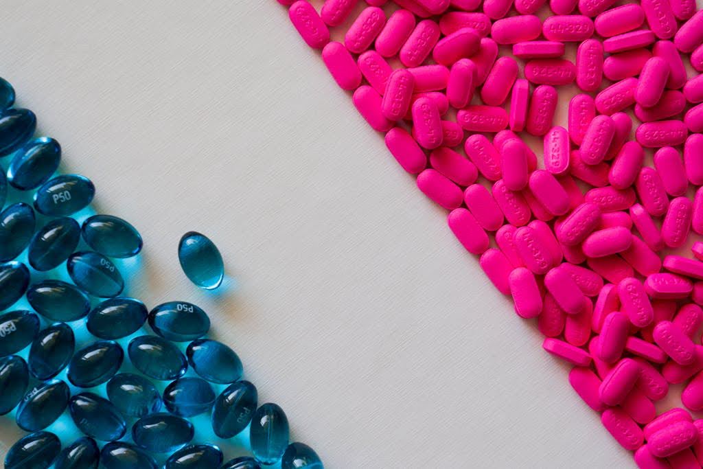Blue gel capsules and pink pills