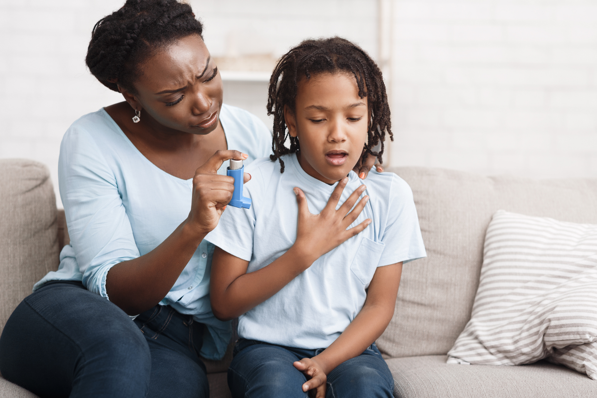Mother helping her child use an asthma inhaler during a breathing difficulty