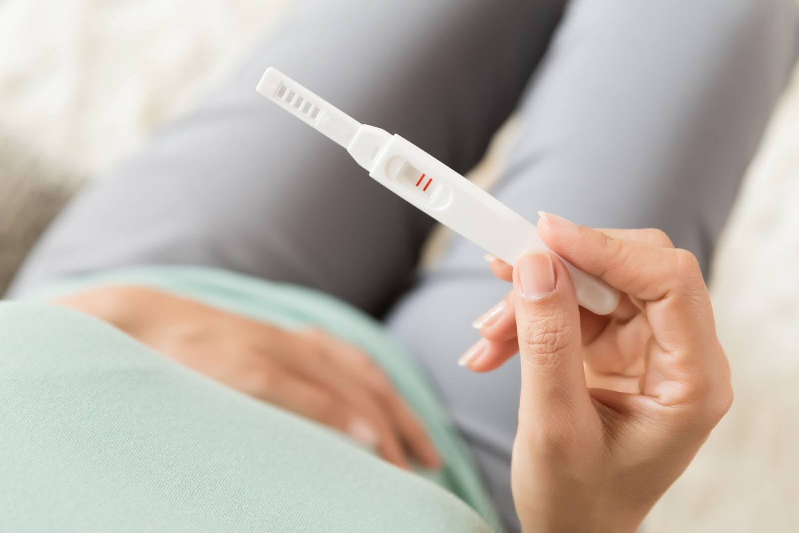 Woman with a pregnancy test positive result