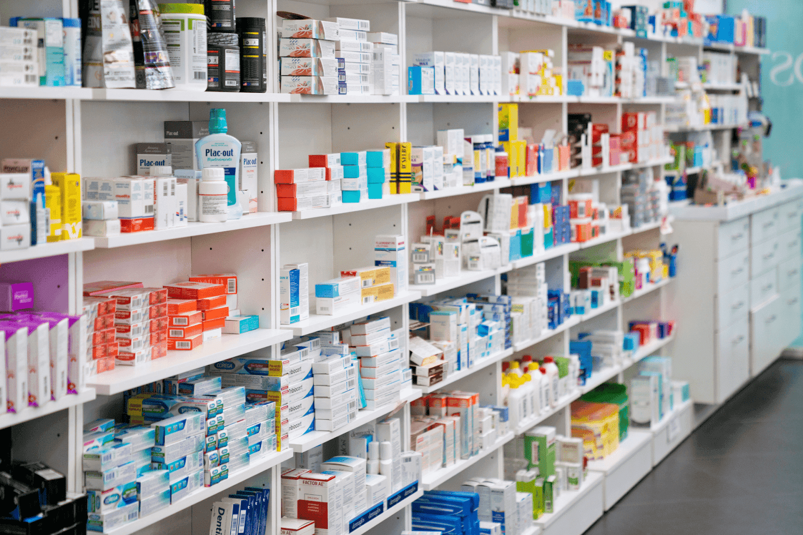 Shelves filled with assorted medicine boxes and healthcare products inside a pharmacy