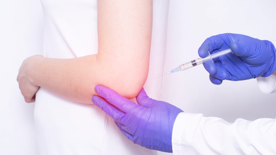 Doctor giving shot in back of arm.