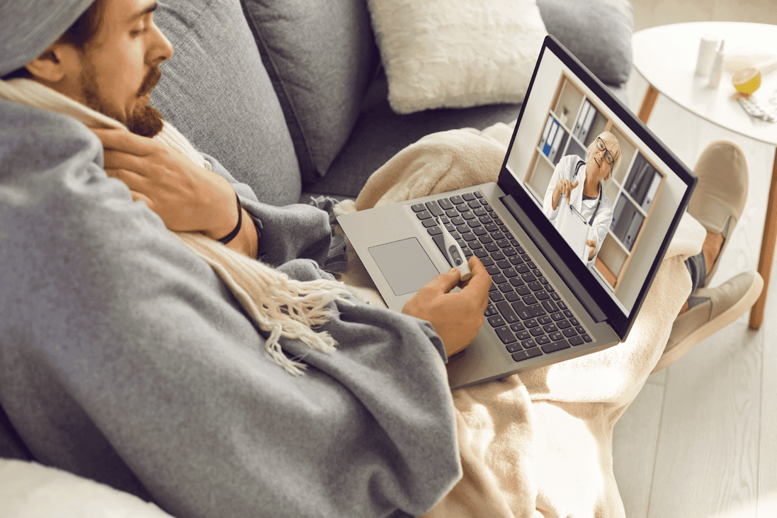 Sick man having an online consultation with a doctor on his laptop.
