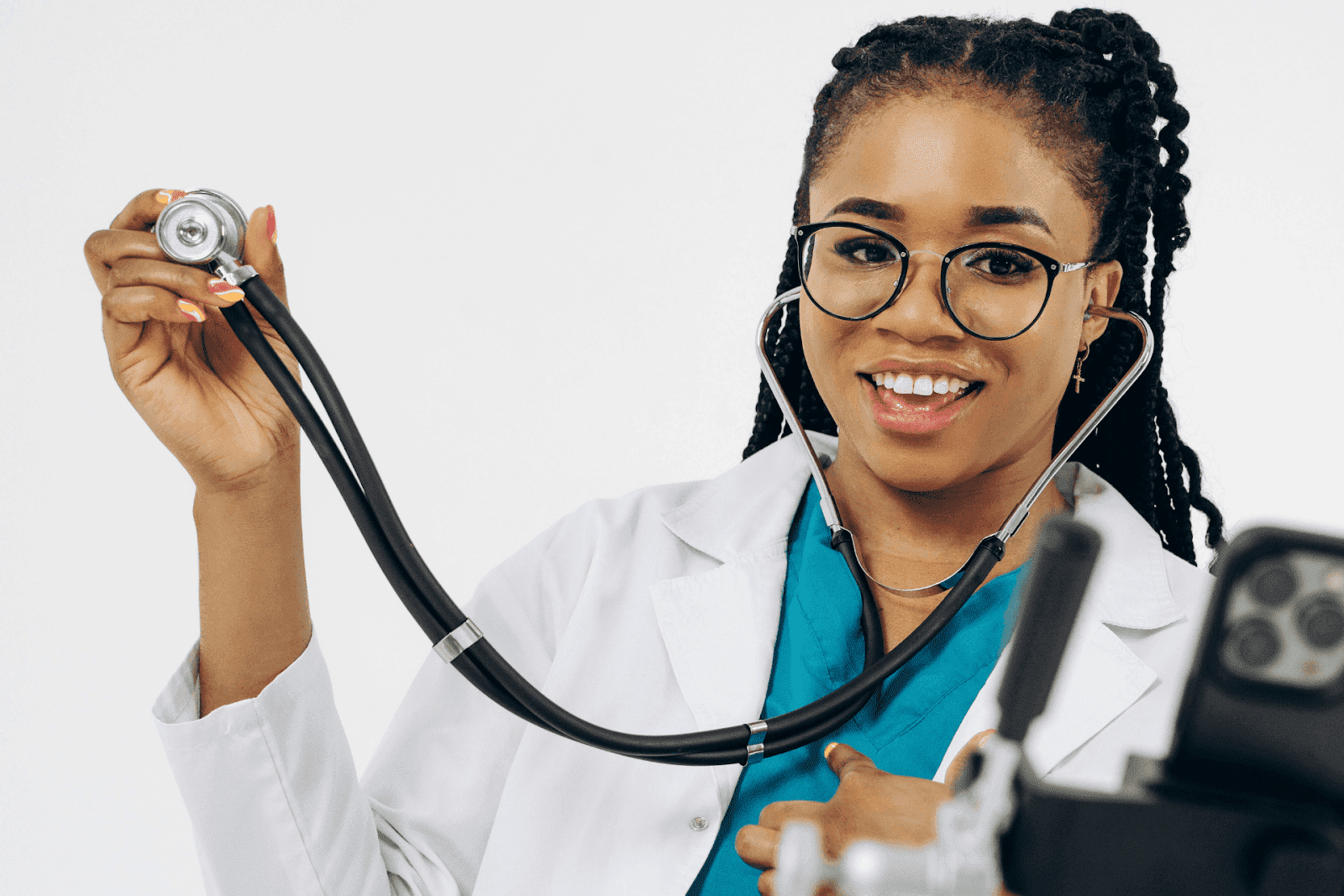Smiling female doctor holding a stethoscope during a virtual consultation