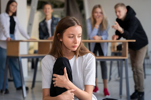 Girl sitting apart from people