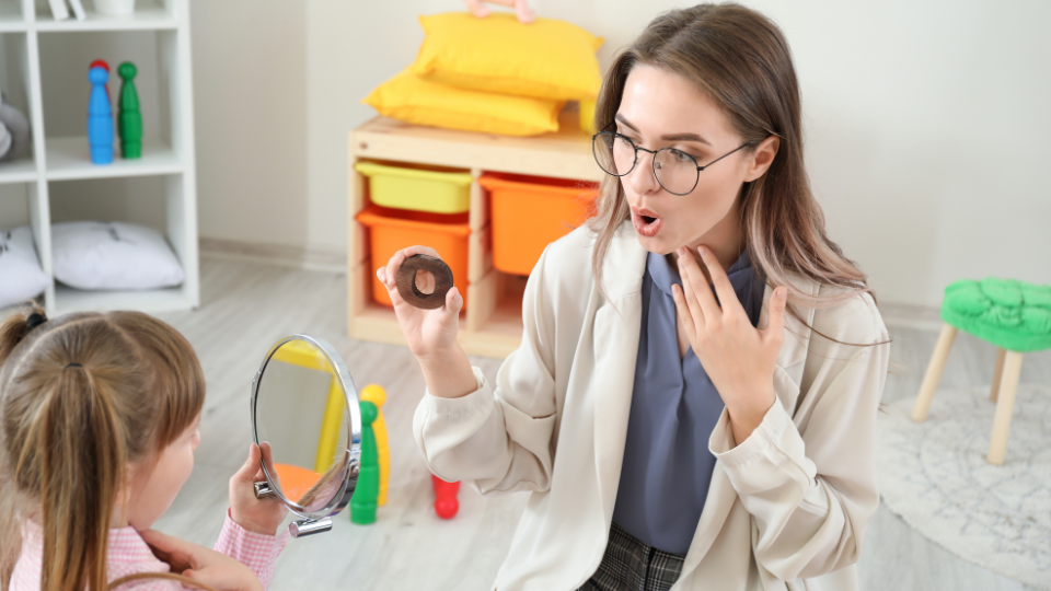 Speech therapist coaching child