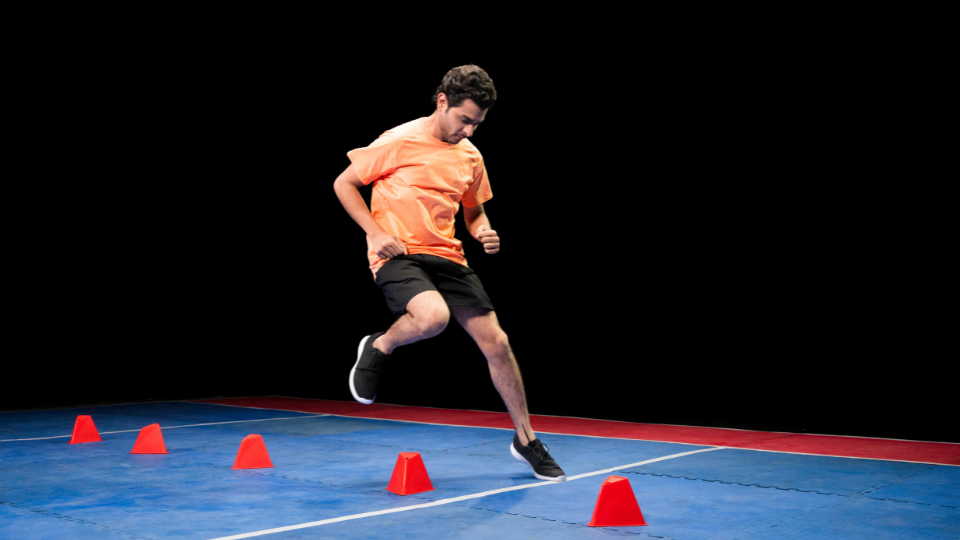 Man running between cones doing a sports drill exercise