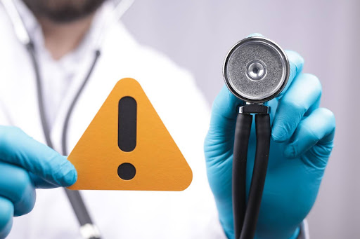 Stethoscope and warning sign