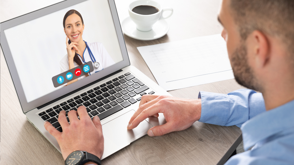 Man on laptop for a telehealth video call with a doctor