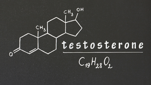 Chemical structure and formula of testosterone drawn on a blackboard.