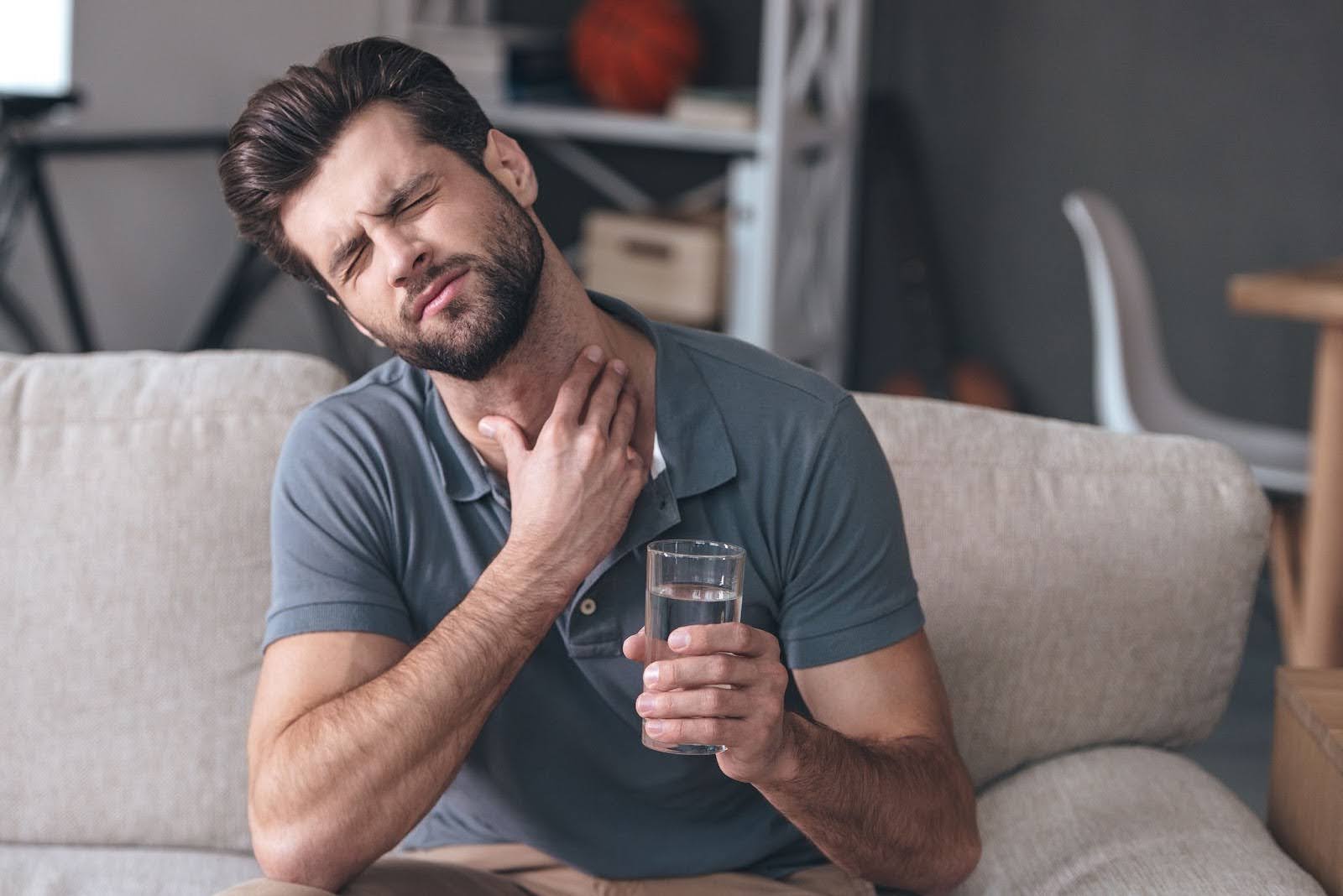Man Touching his Throat Due to Pain