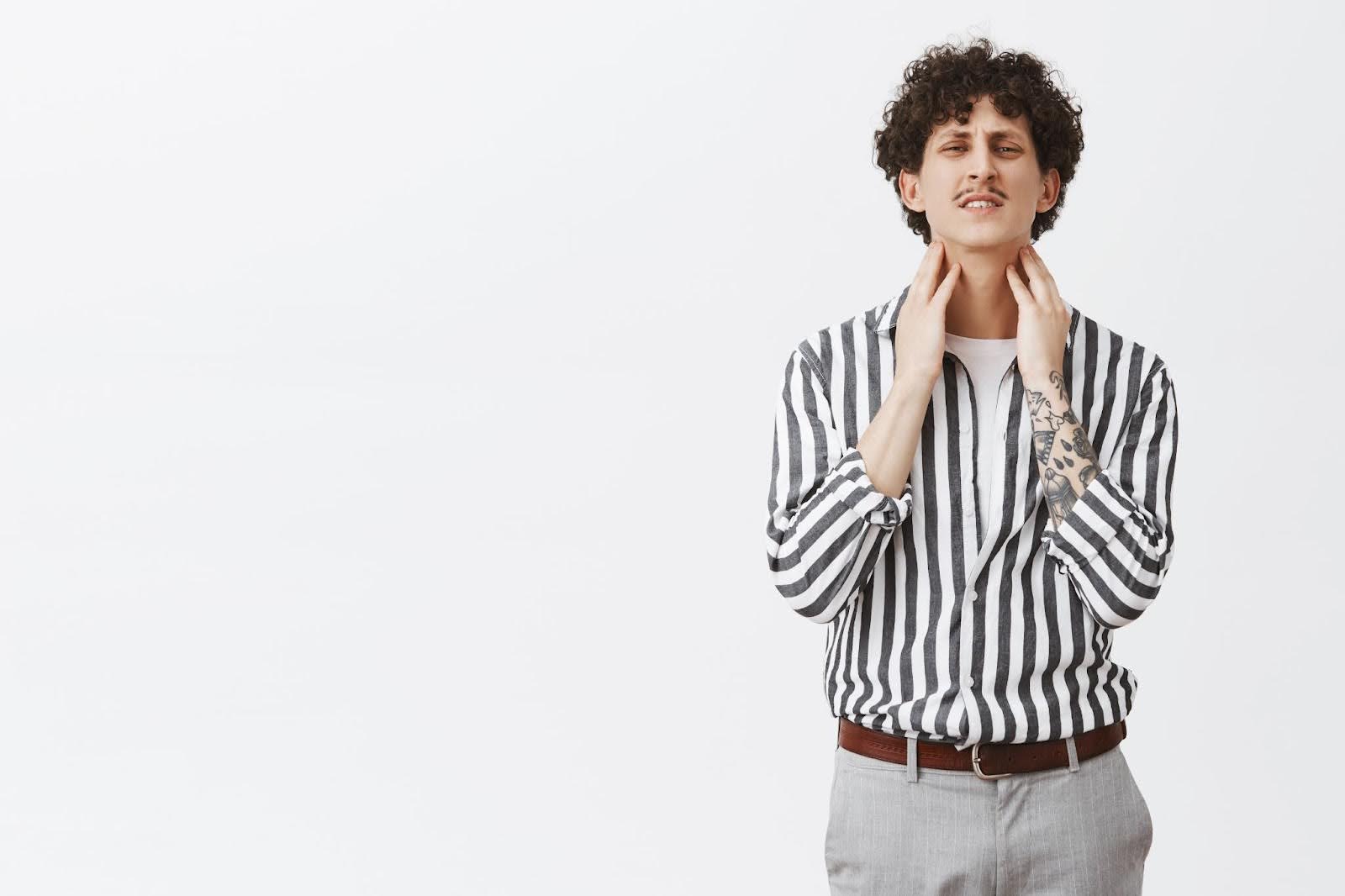 Man Feeling Throat Pain