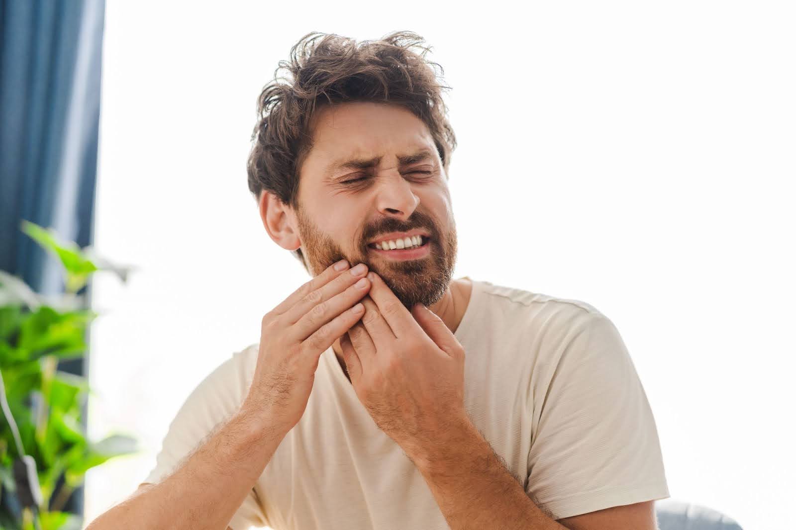 Man Holding the Face Due to Tooth Pain