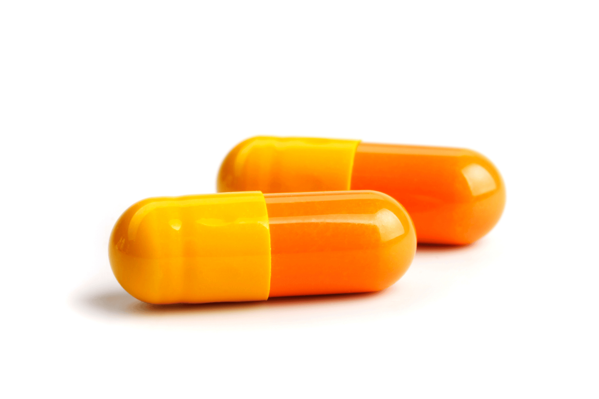 Two orange and yellow capsules on a white background.