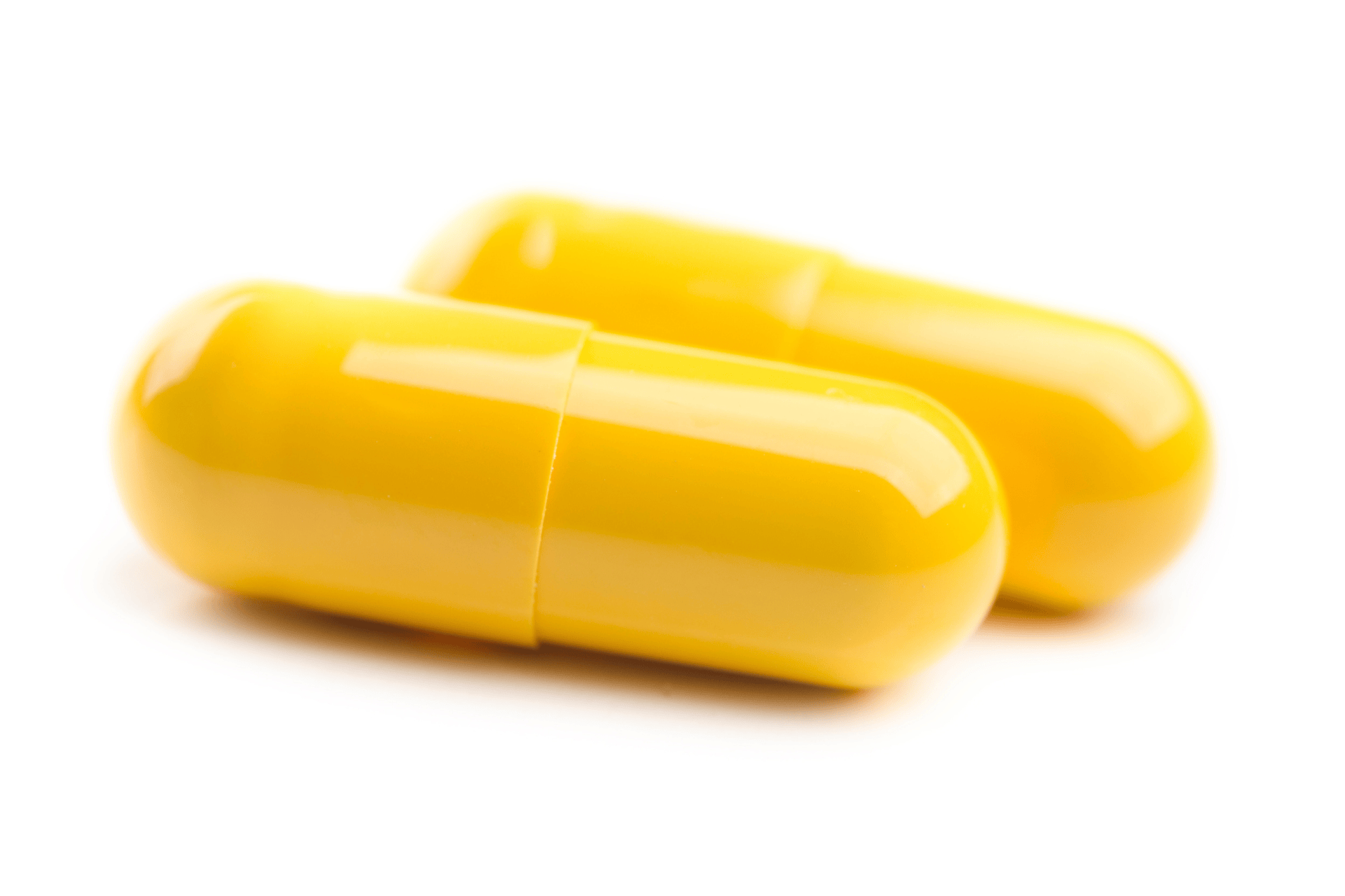 Two yellow capsules on a white background.
