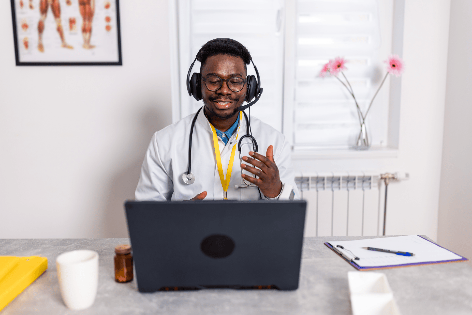 Doctor wearing a headset, smiling and speaking during an online consultation.