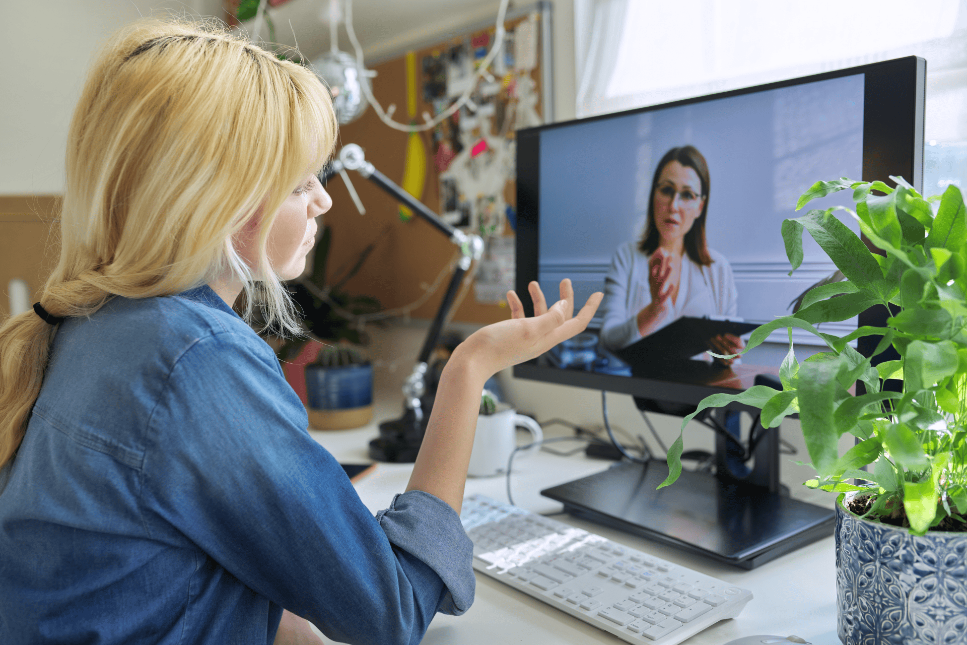 Woman having an online video call with a doctor on a computer.