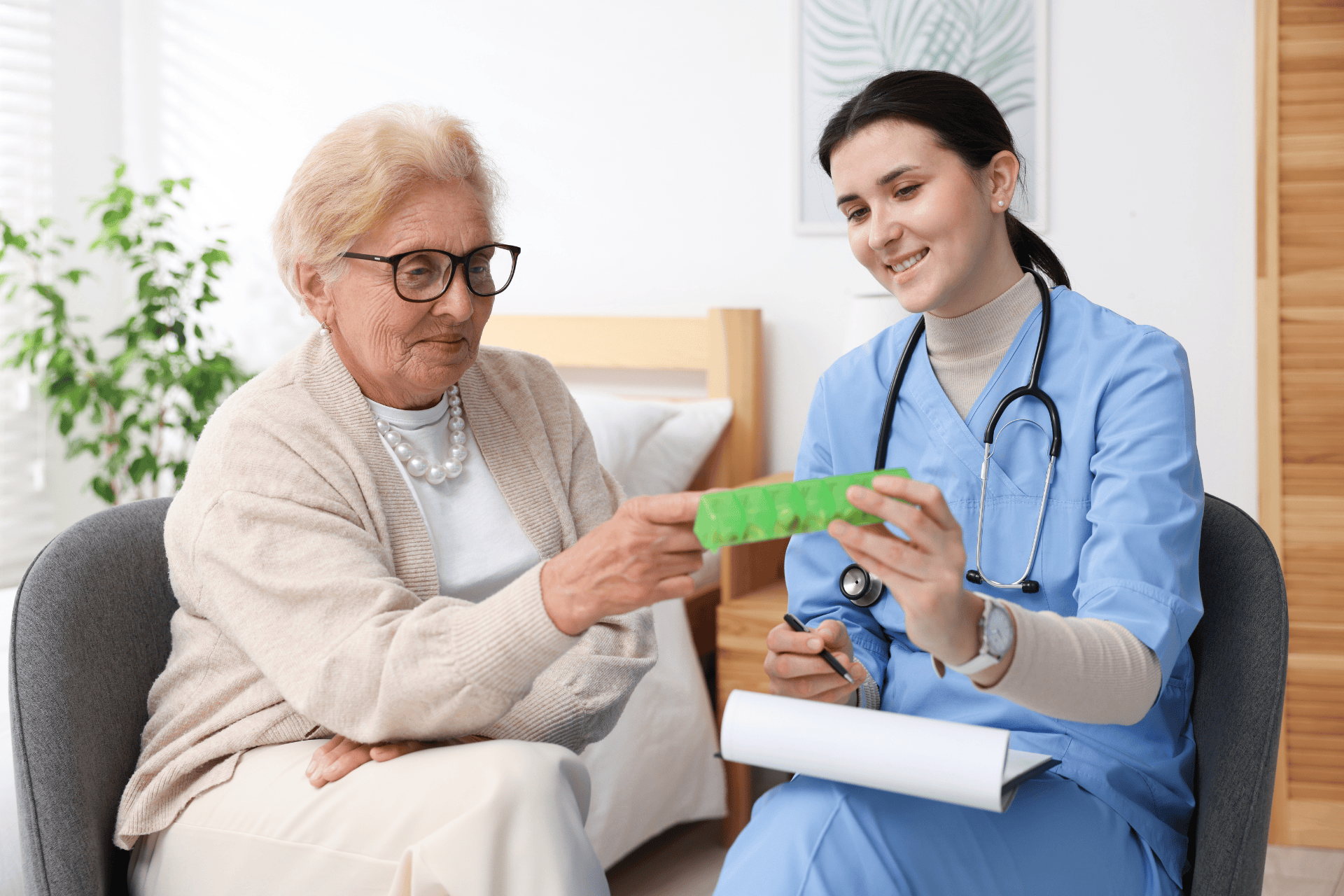 Doctor helping an elderly woman with her medication.