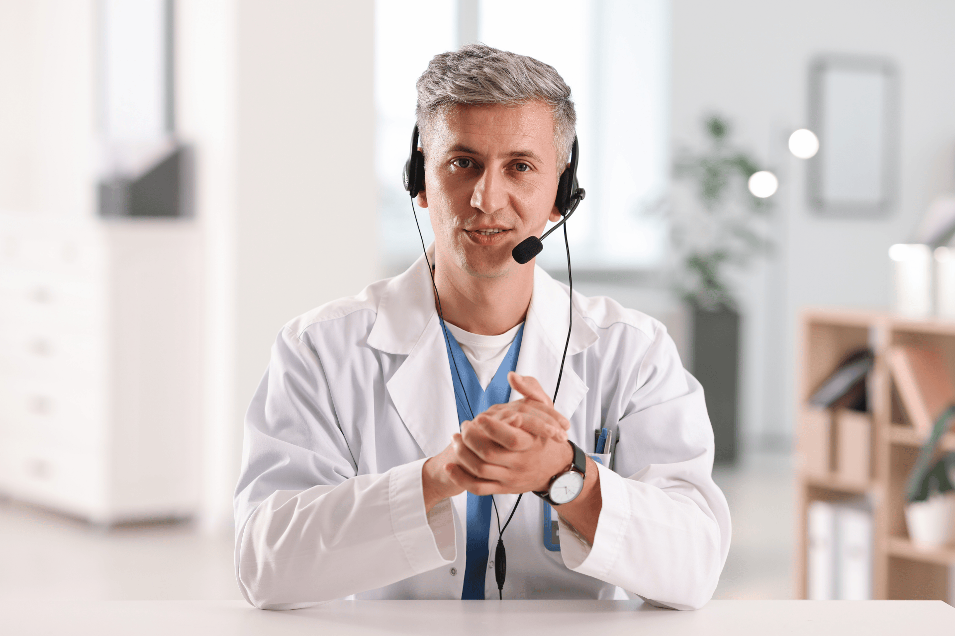 Doctor wearing a headset speaking during a virtual consultation.