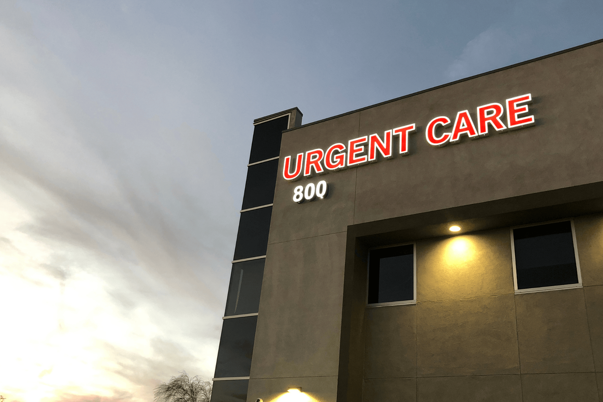 Exterior of an urgent care clinic with illuminated sign.