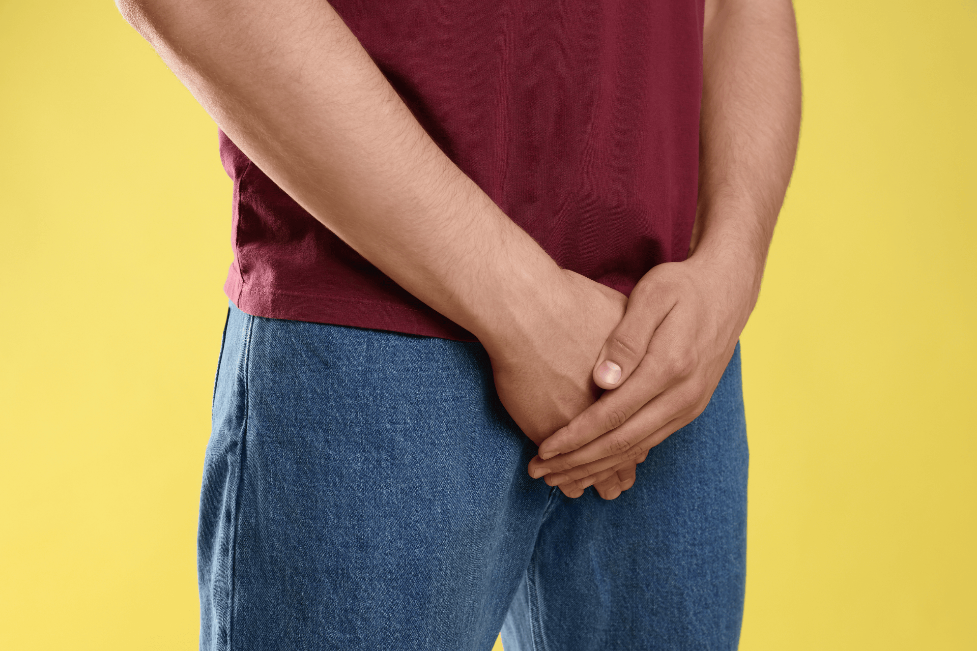 Man holding his groin area, suggesting erectile dysfunction or discomfort.