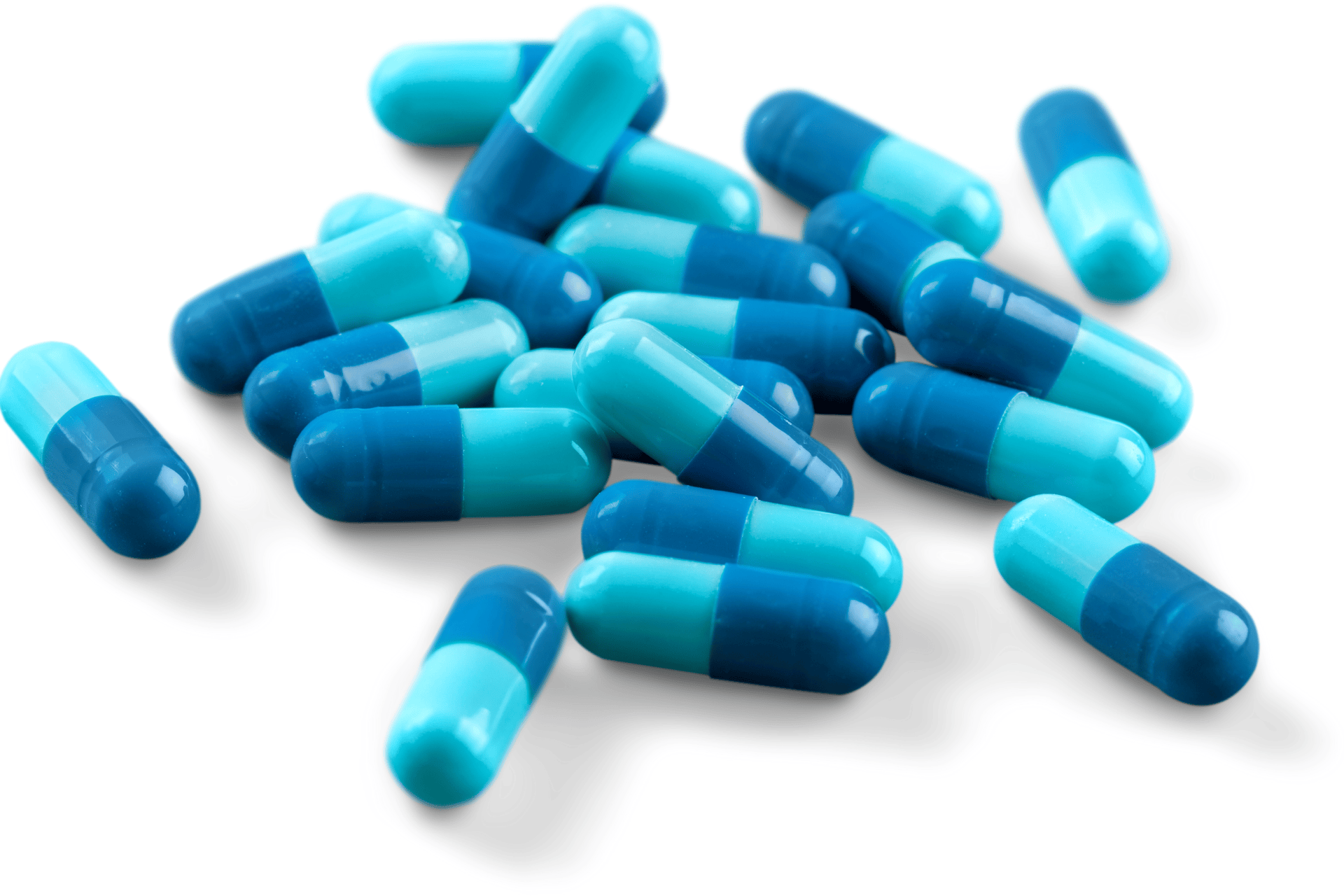 Pile of blue and teal capsules on a white background.