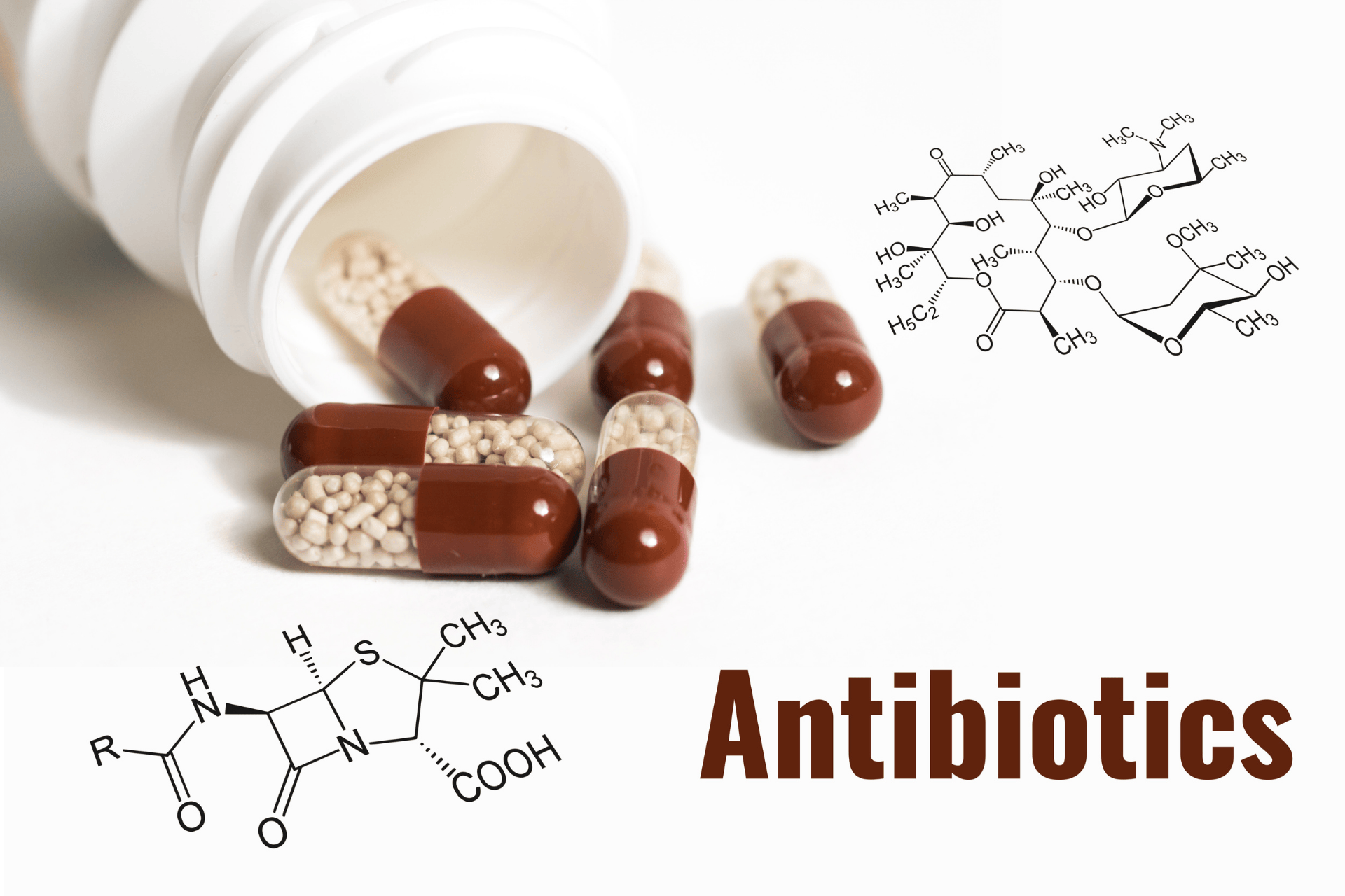 Antibiotic capsules spilling from a bottle, accompanied by chemical structure diagrams and the word “Antibiotics.”