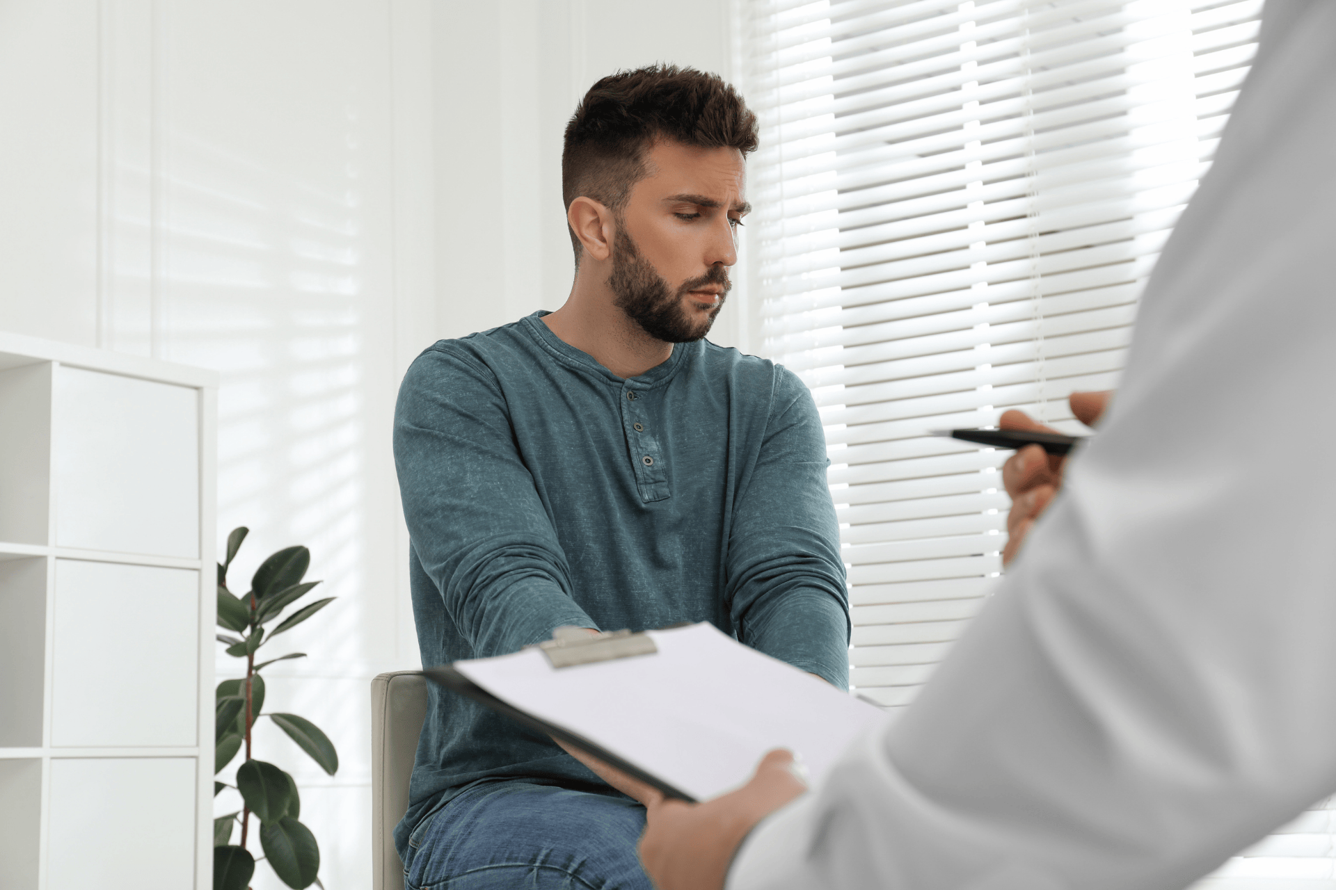 Man looking away while sitting during a medical consultation