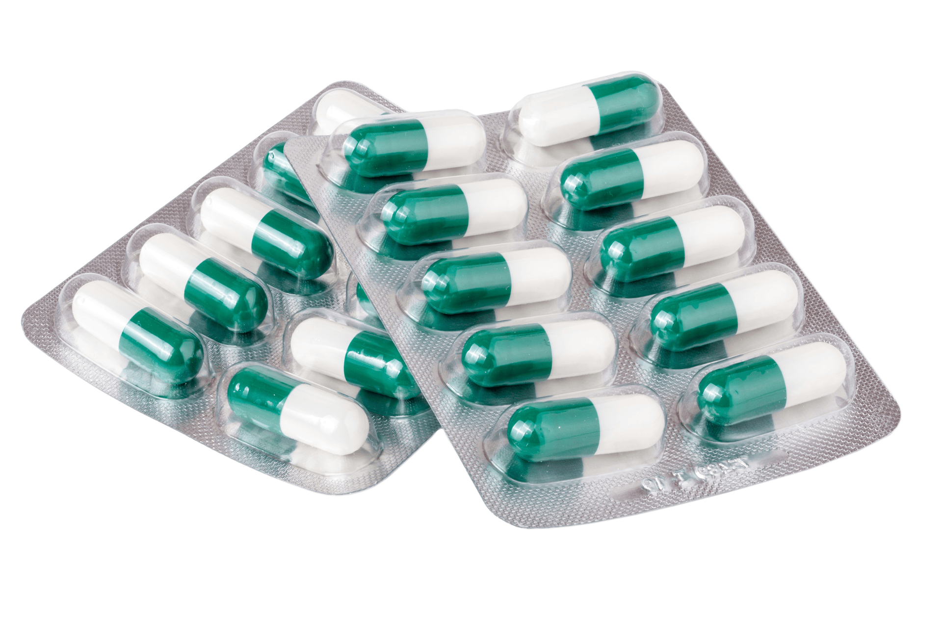 Green-and-white capsules in blister packs on a white background.