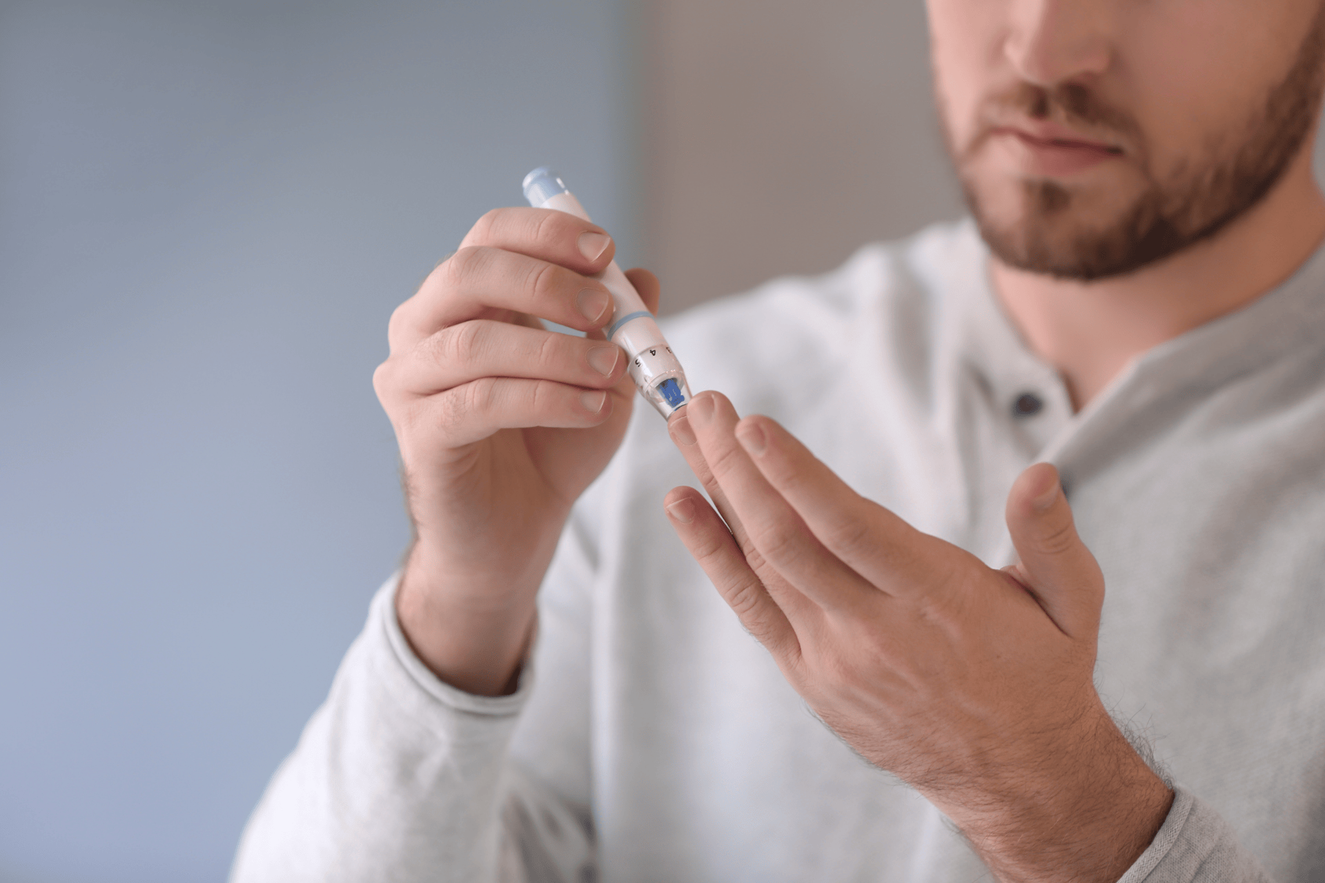 Man checking blood sugar with a finger-prick glucose test.