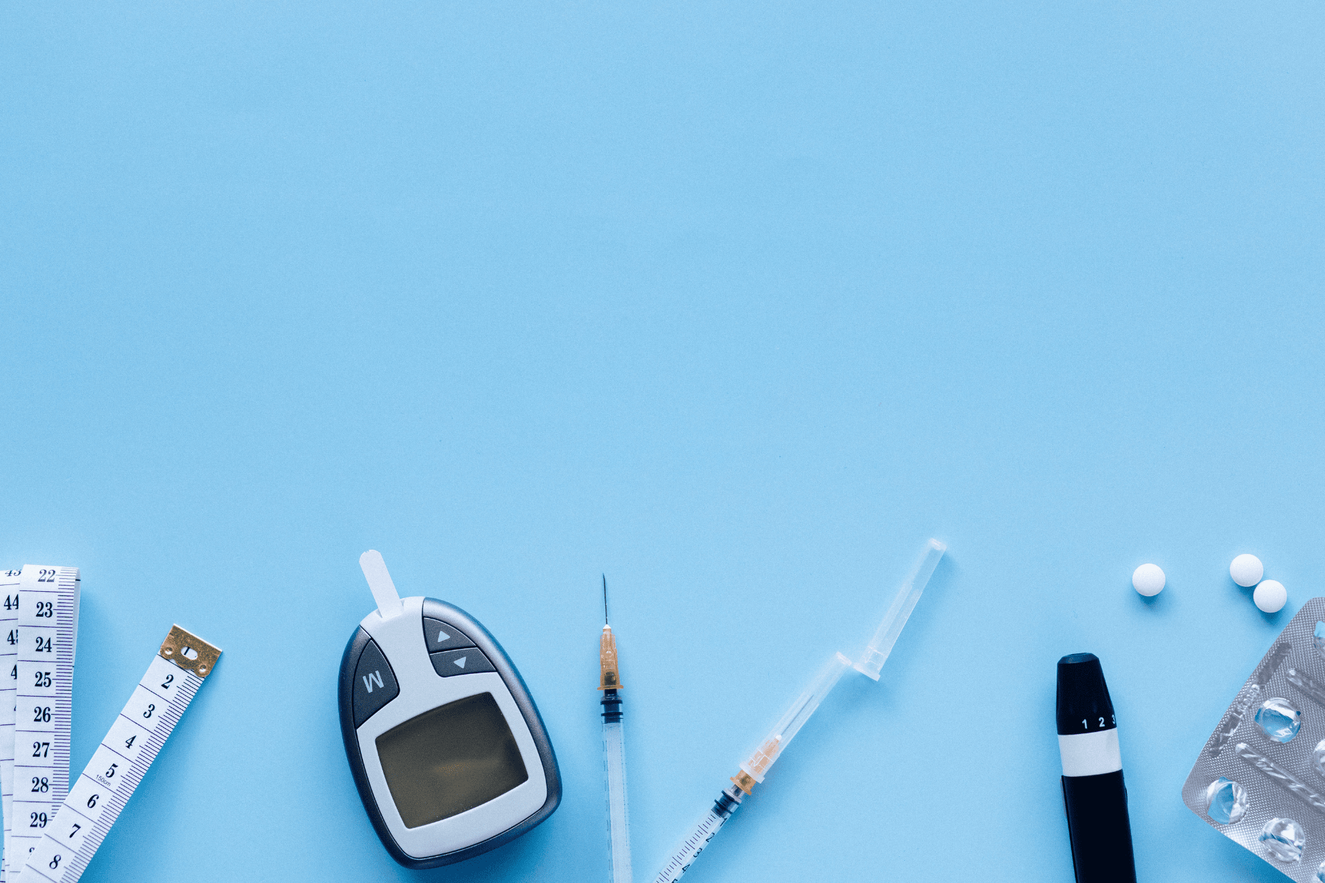 Diabetes care essentials glucose meter, insulin syringes, test strips, and medication.