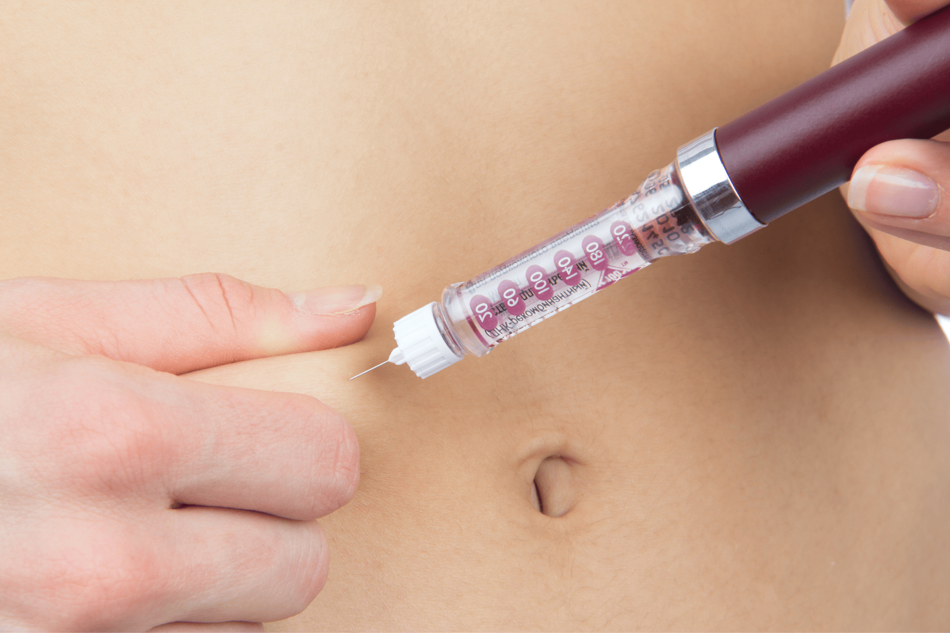 Insulin injection in the abdomen for blood sugar control in diabetes management.