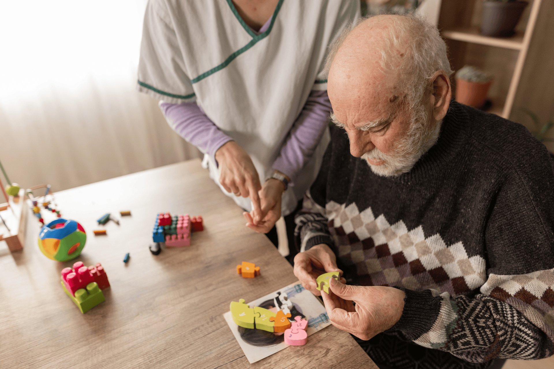 Caregiver assisting an older adult with dementia during a cognitive activity using puzzle pieces.