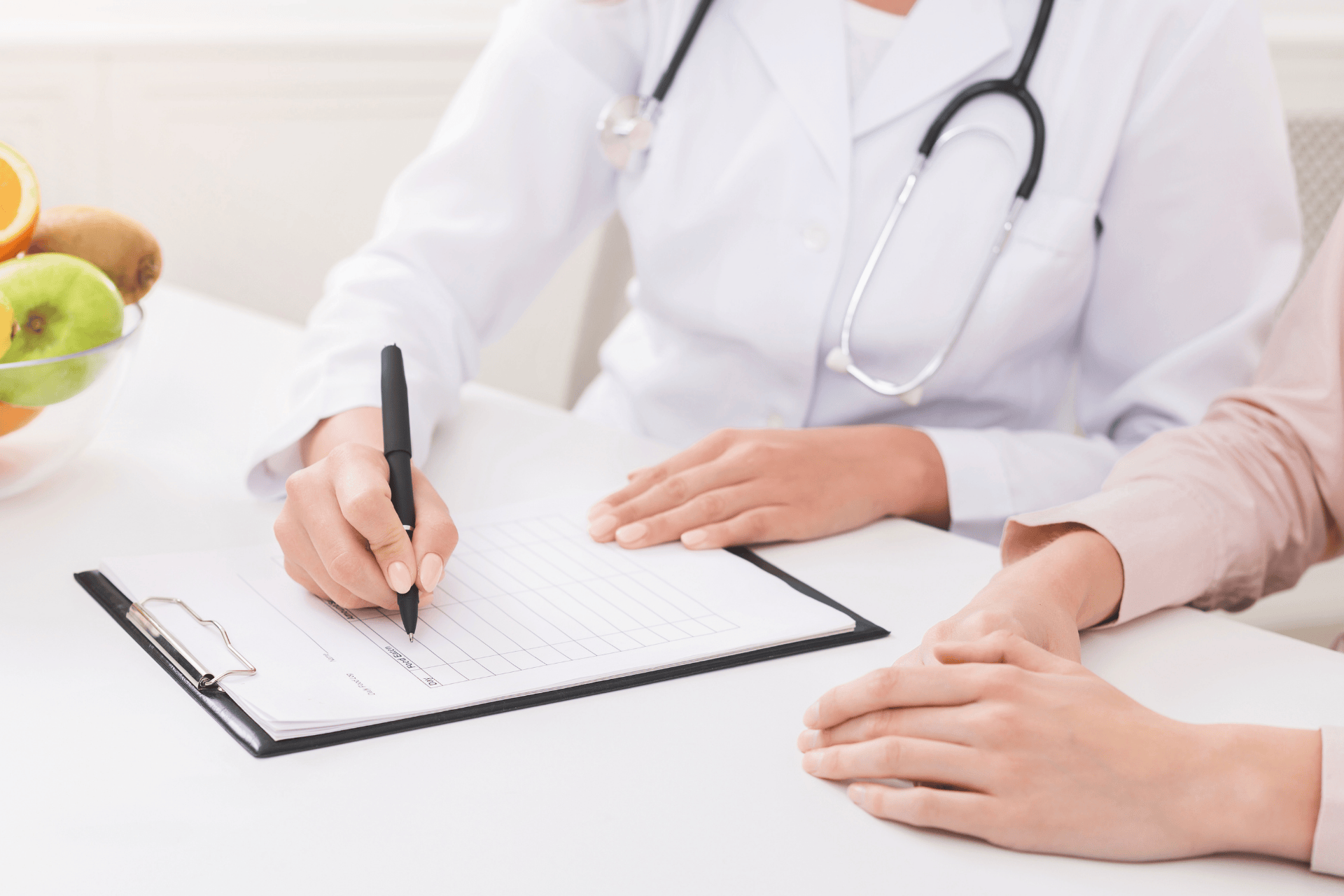 Doctor writing a medical prescription and treatment plan for diabetes management during a patient consultation.