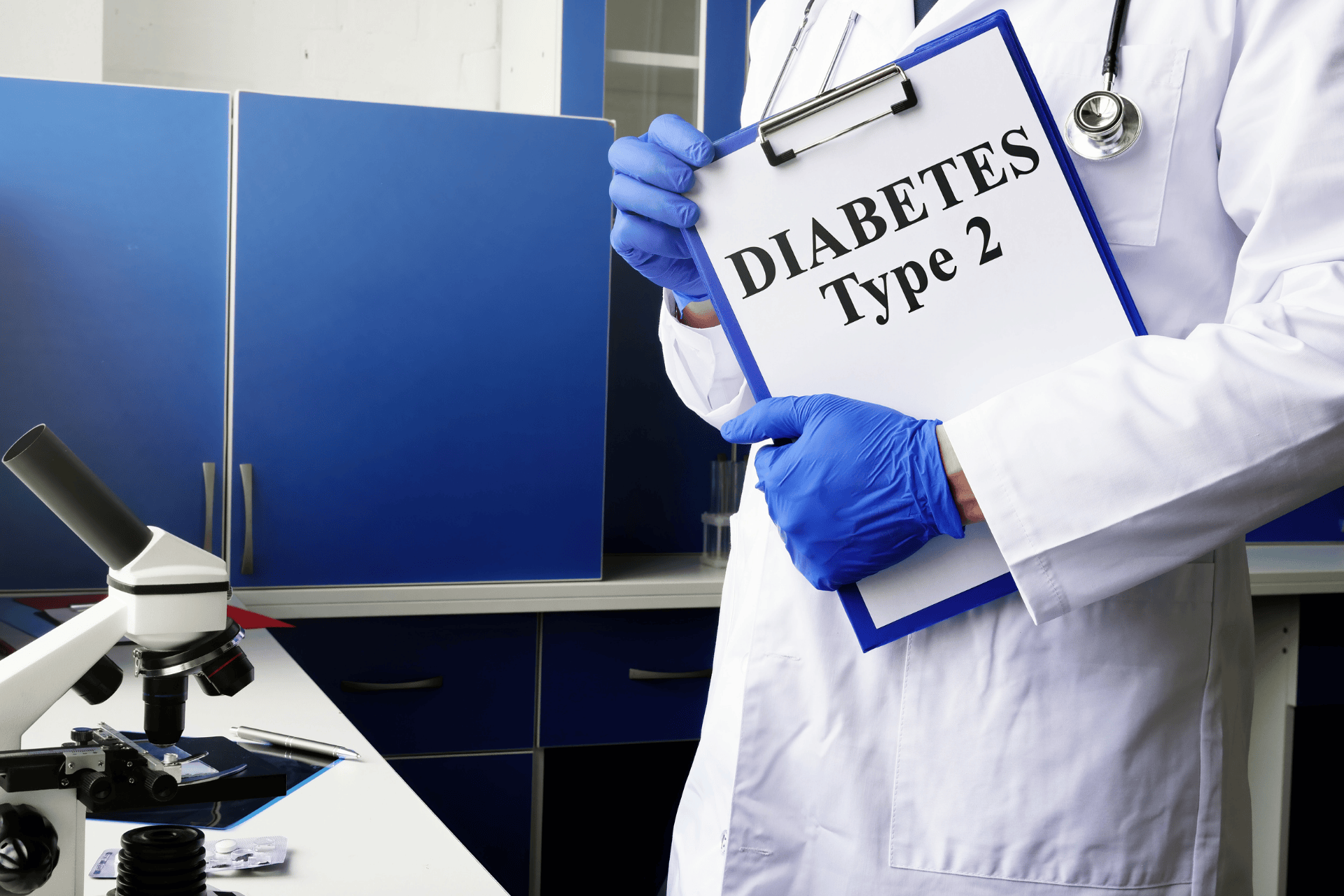 Doctor in a lab holding a clipboard labeled “Diabetes Type 2” beside a microscope.