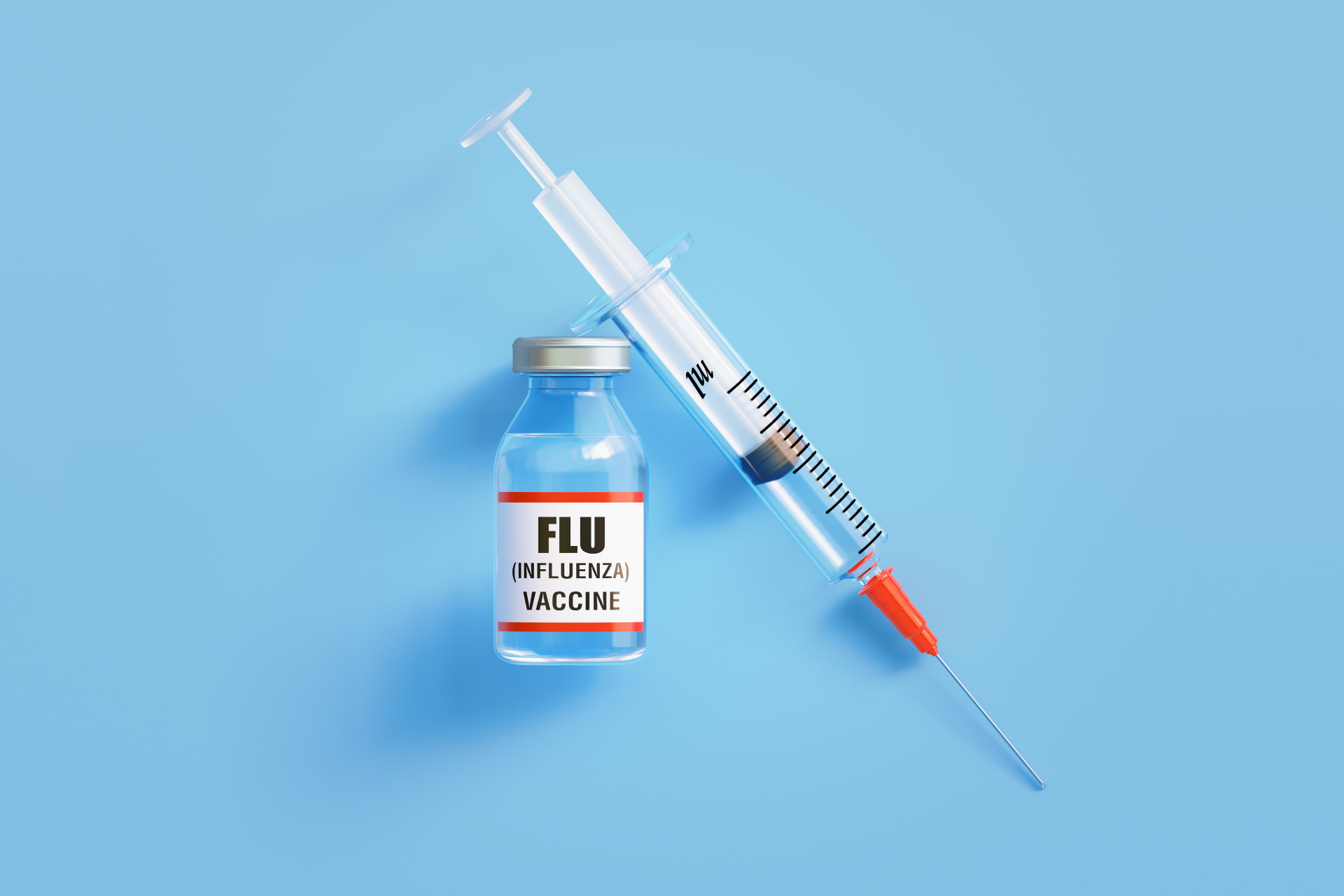 Vial labeled “Flu (Influenza) Vaccine” next to a syringe on a light blue background
