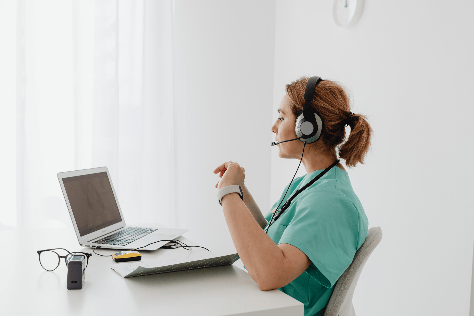 Healthcare professional wearing a headset conducting an online consultation.