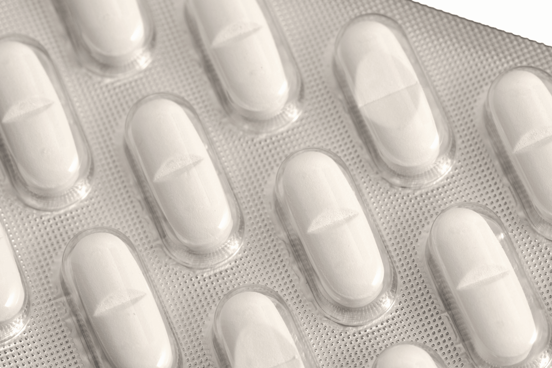 Close-up of white pills in a blister pack.
