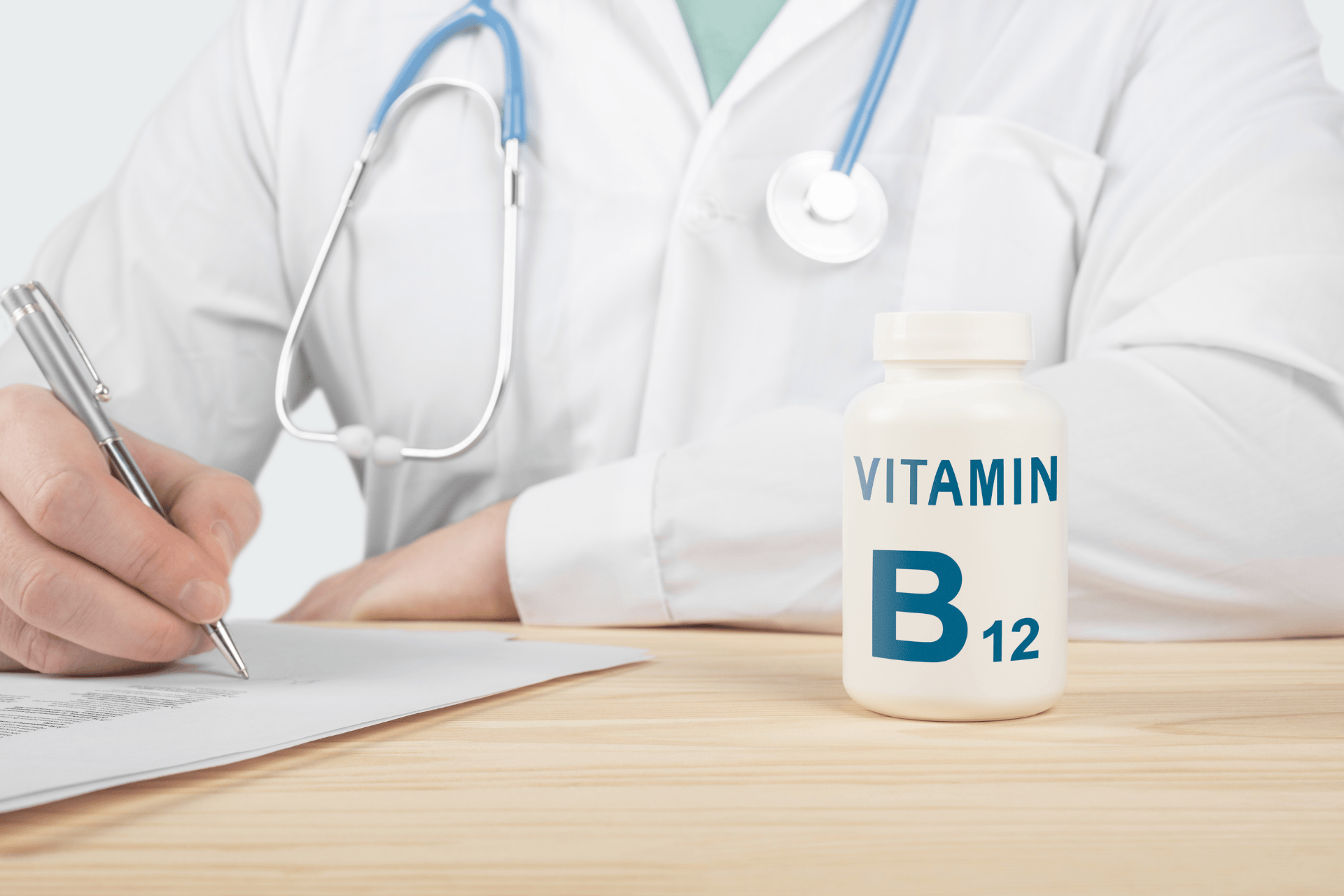 Doctor writing notes beside a bottle labeled Vitamin B12.