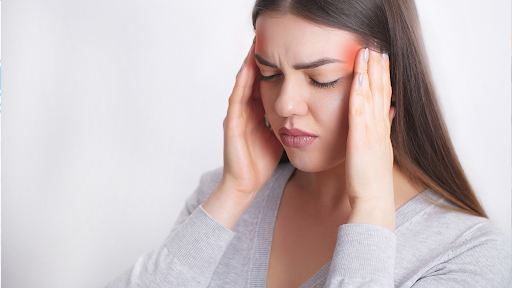 Woman holding her head due to a headache
