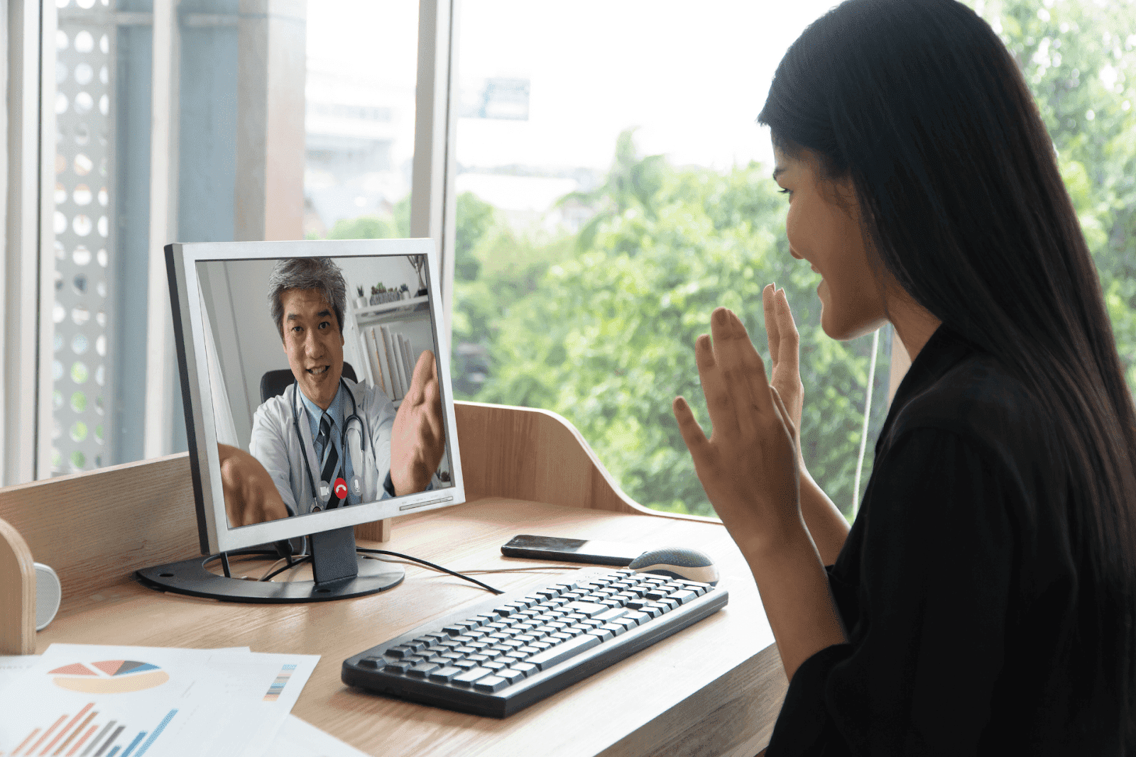 Woman having an online video consultation with a doctor on a computer.