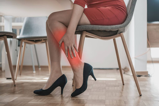 Woman Suffering from Leg Pain Wearing Heels