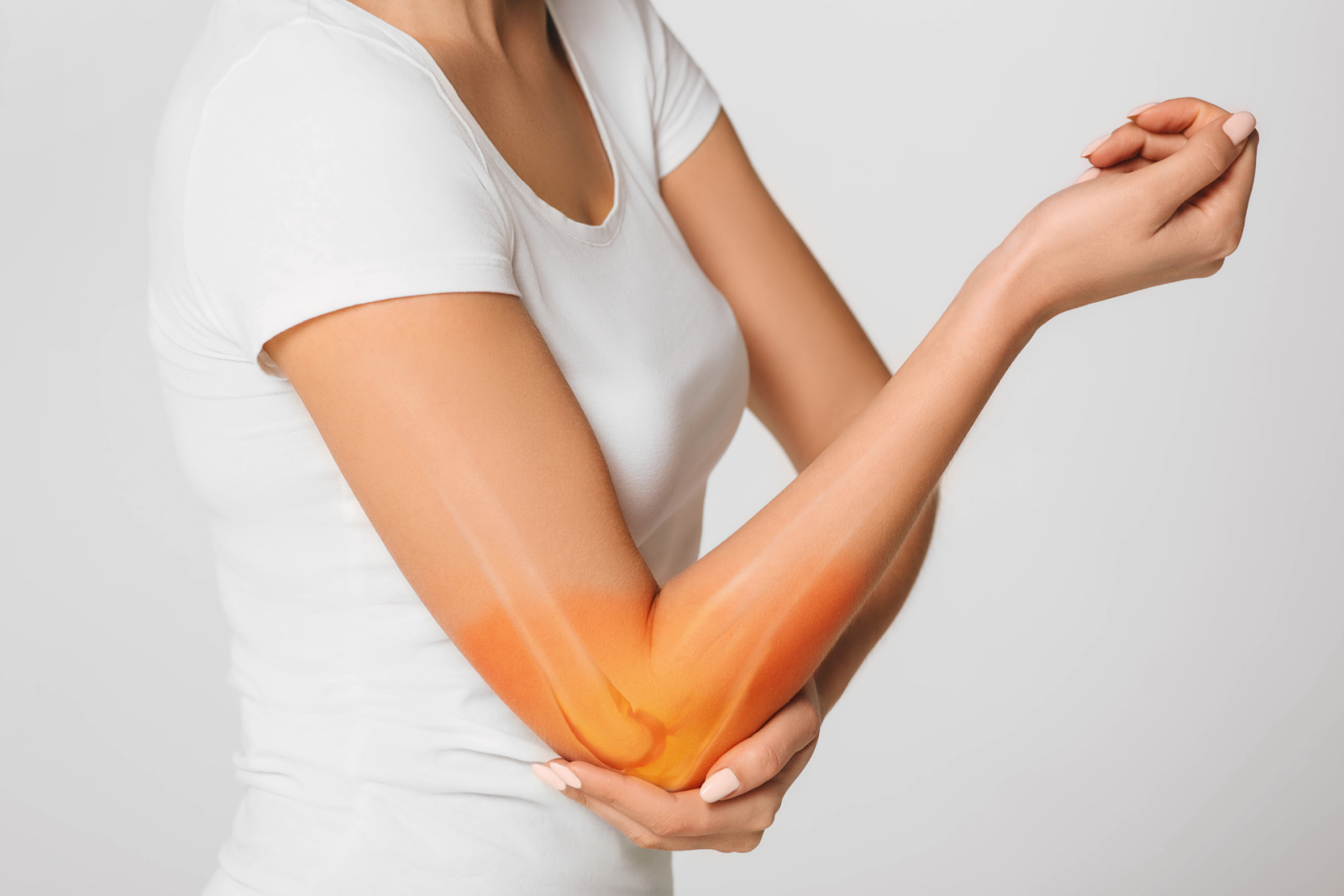 Woman holding her elbow in pain with highlighted joint area.