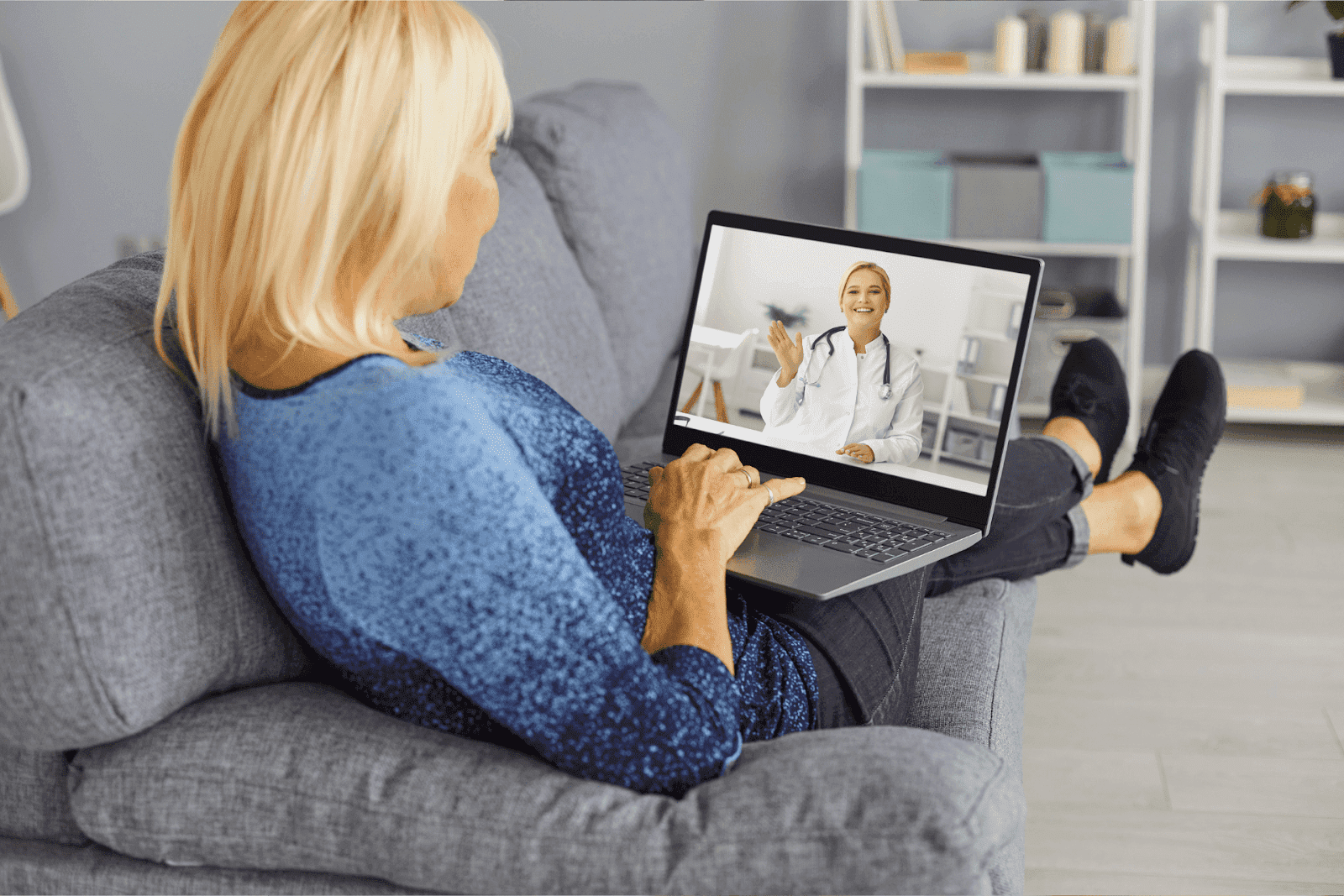 Woman on a couch having an online consultation with a doctor.